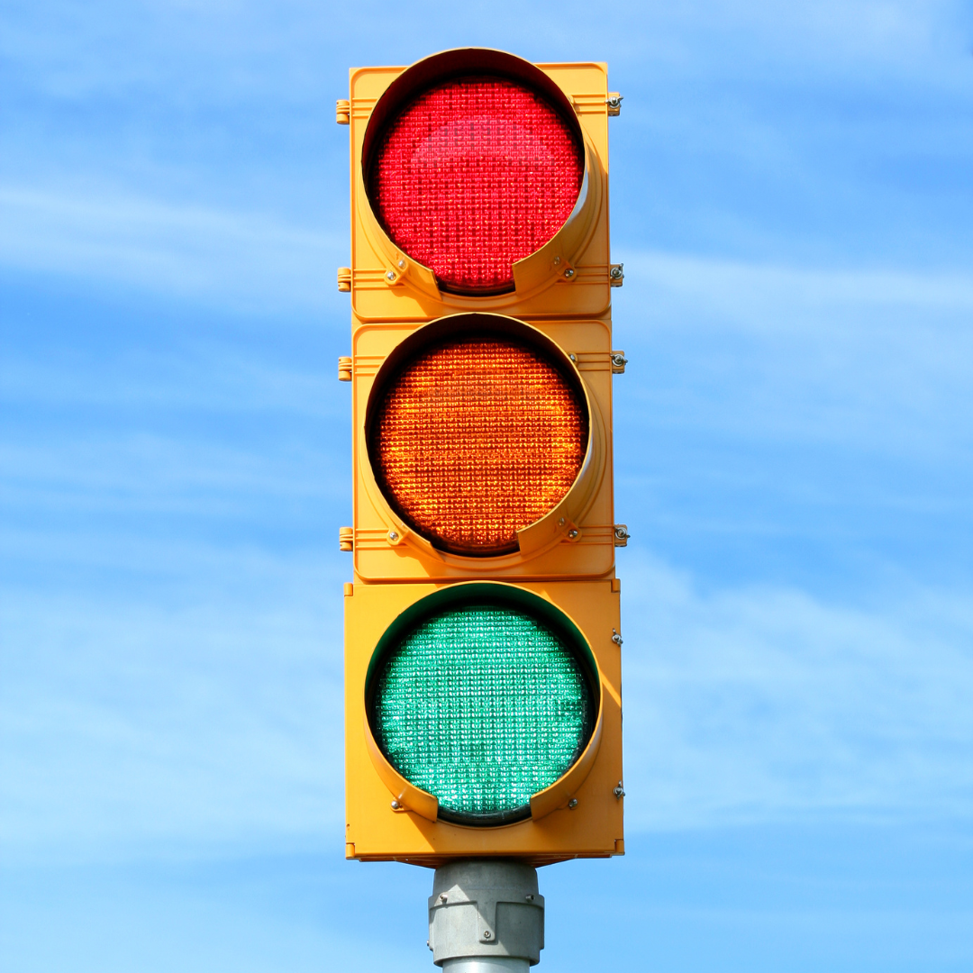 Bright traffic light against a clear blue sky